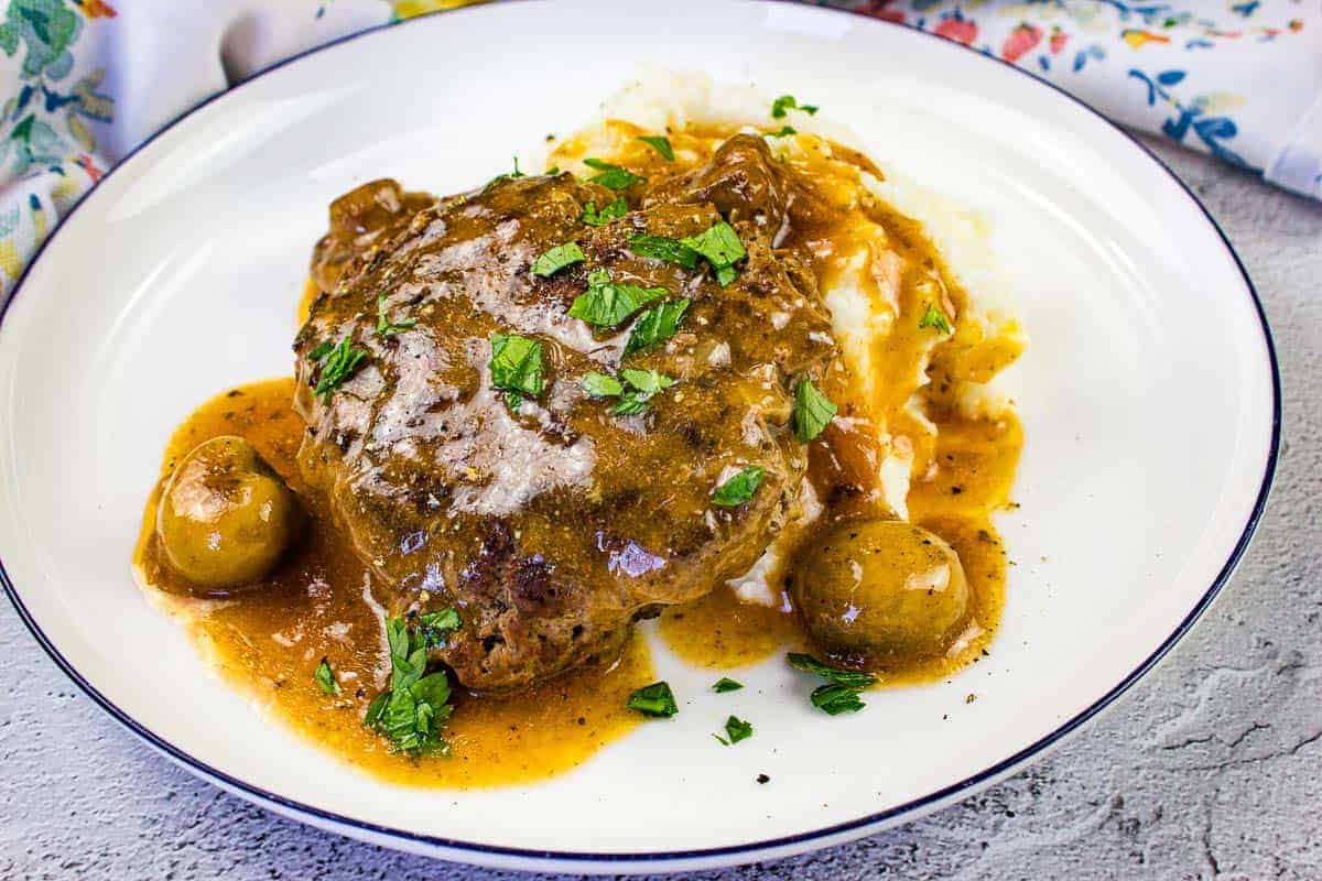 Salisbury Steak on a bed of mashed potatoes.