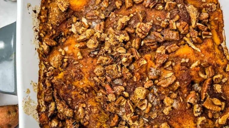 A close-up of Sweet Potato Casserole on a white dish.