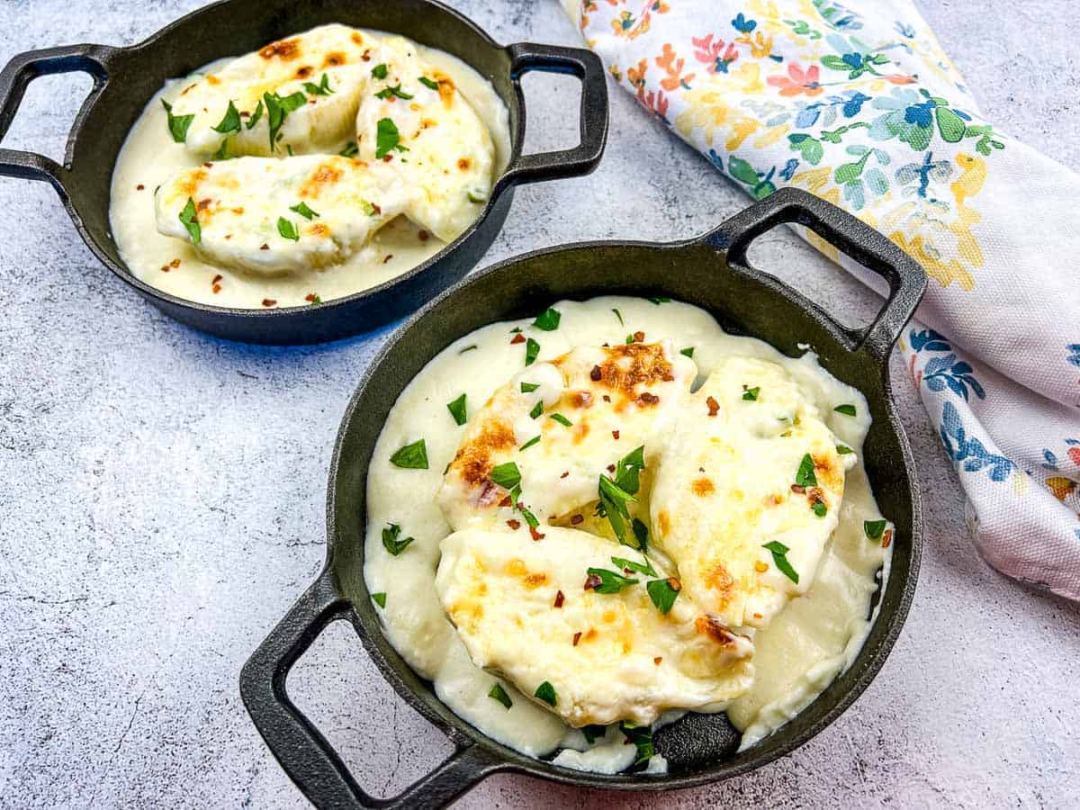 Giant Cheese Stuffed Pasta Shells in two black serving dishes.