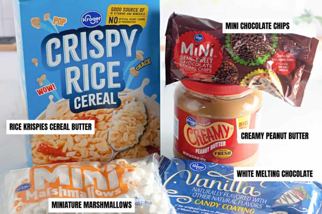 Ingredients for Avalanche cookies: Rice Krispies cereal, miniature marshmallows, mini semi-sweet chocolate chips, creamy peanut butter, and white melting chocolate, with labels on each item.