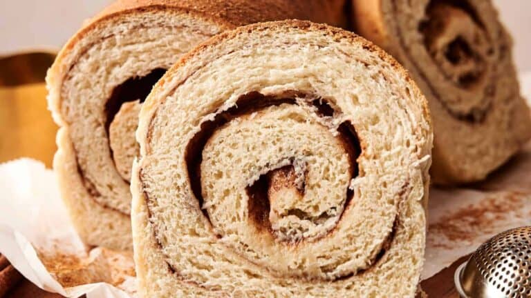 Close-up of cinnamon swirl bread slices, showcasing a spiral pattern in the texture.