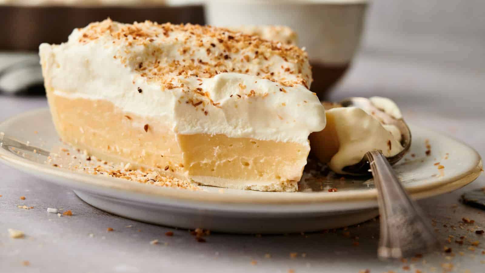 A slice of coconut cream pie on a plate.