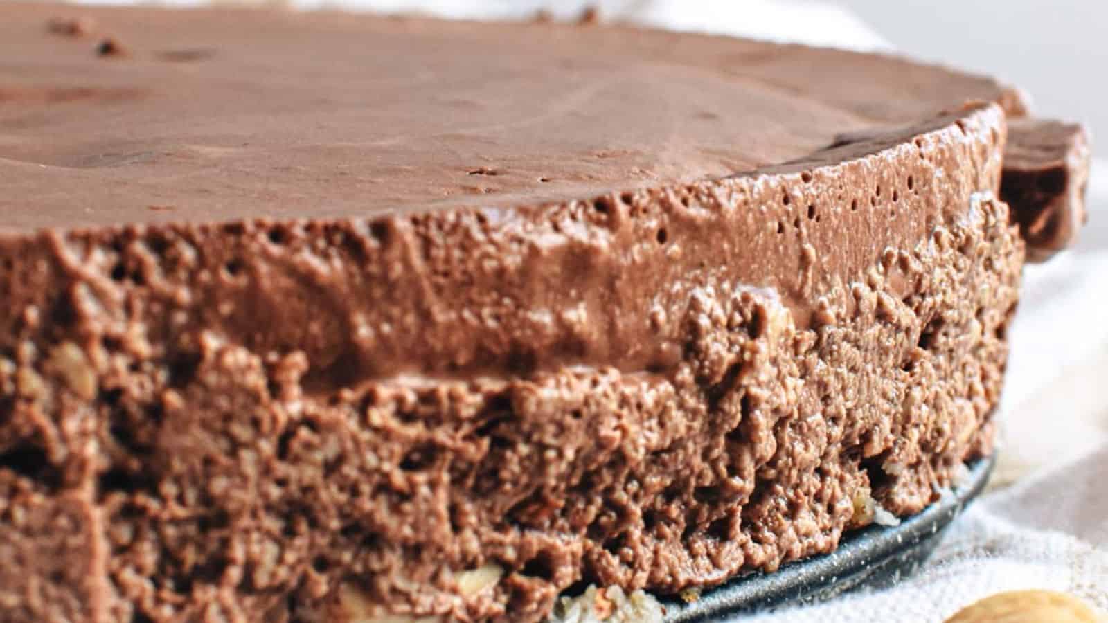 Close-up of a decadent raw vegan chocolate cake with a rich, creamy texture.