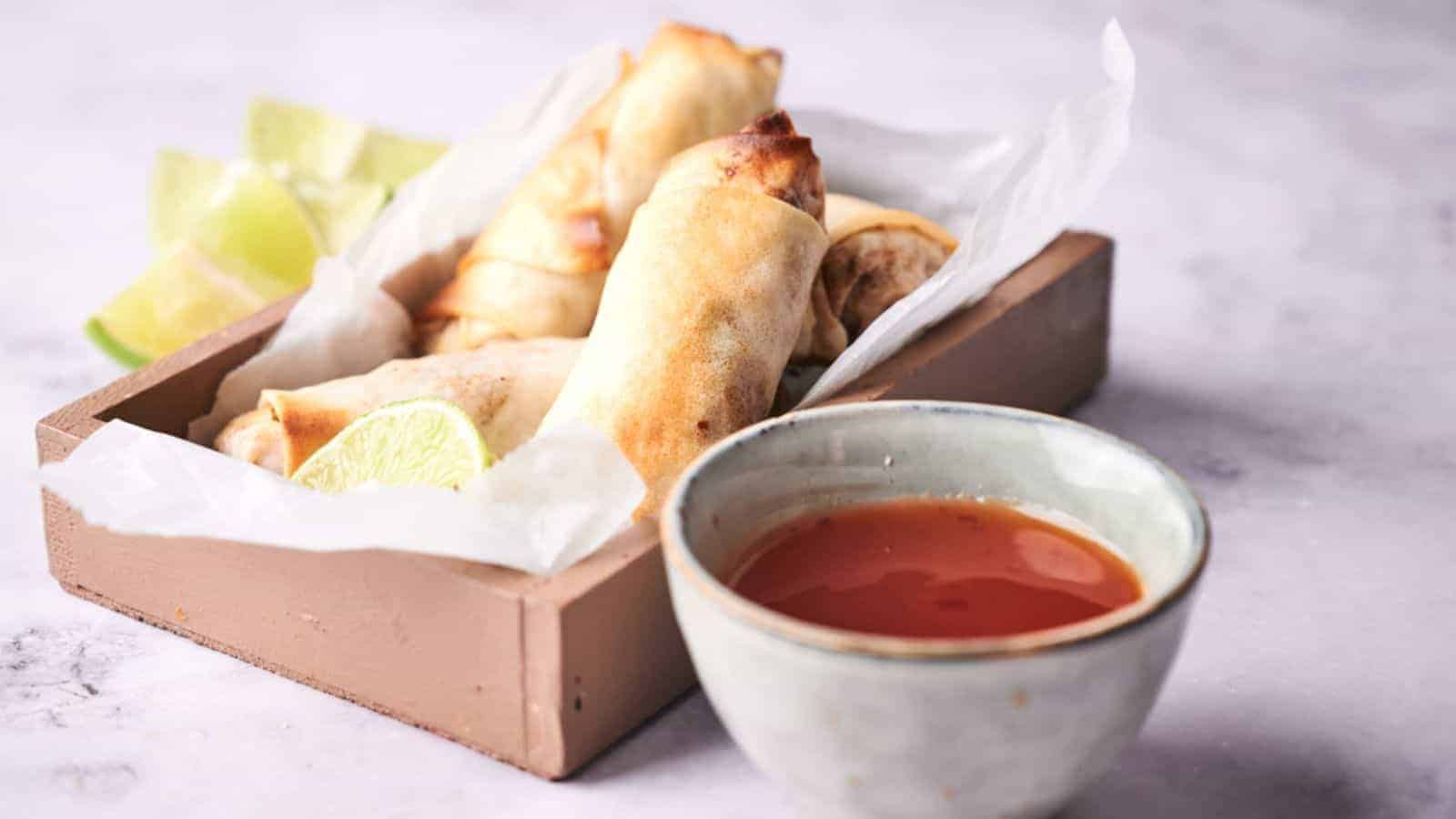 Vegan egg rolls in a wooden tray.