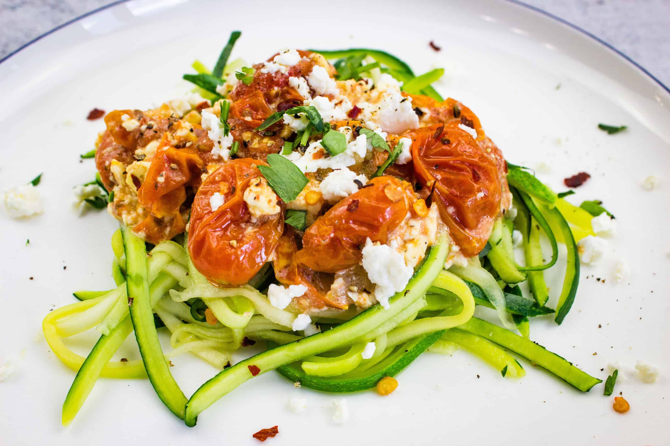 A plate of Low-Carb Baked Feta Pasta garnished with fresh herbs.