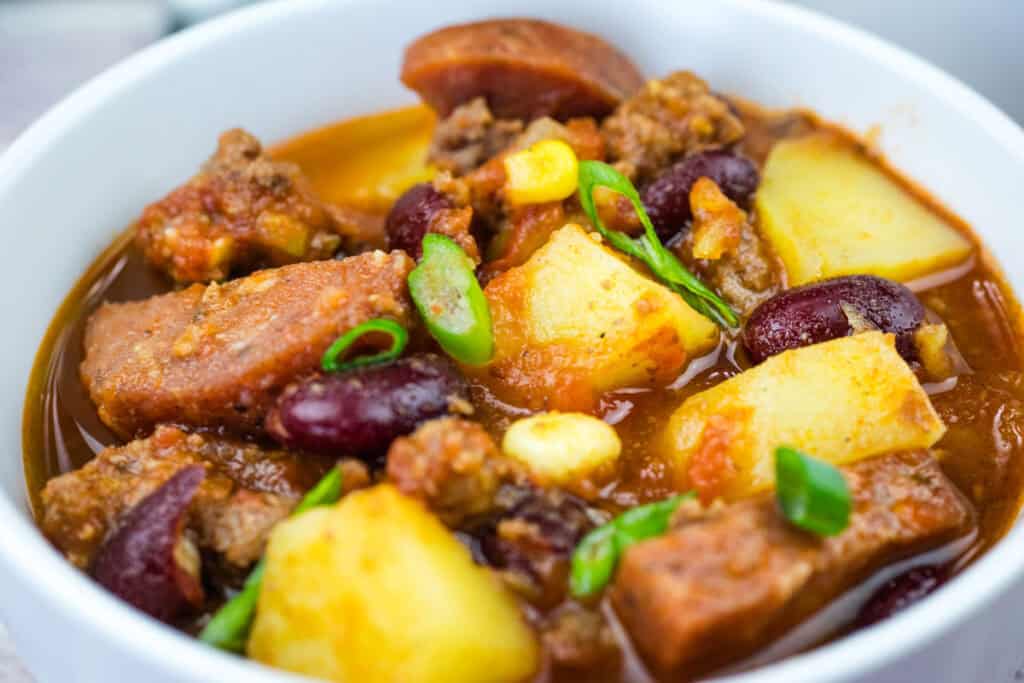 A bowl of Texas cowboy stew garnished with green onions.