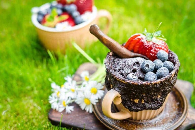 A chocolate cake in a cup topped with berries.