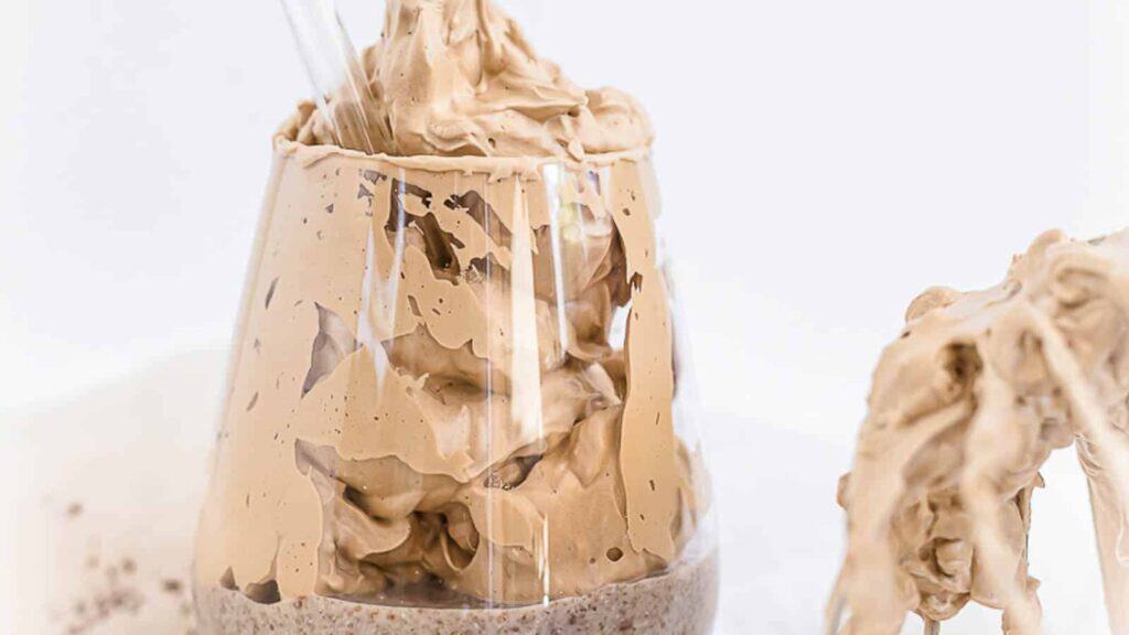 Dalgona Coffee Chia Seed Pudding in a glass with a straw.