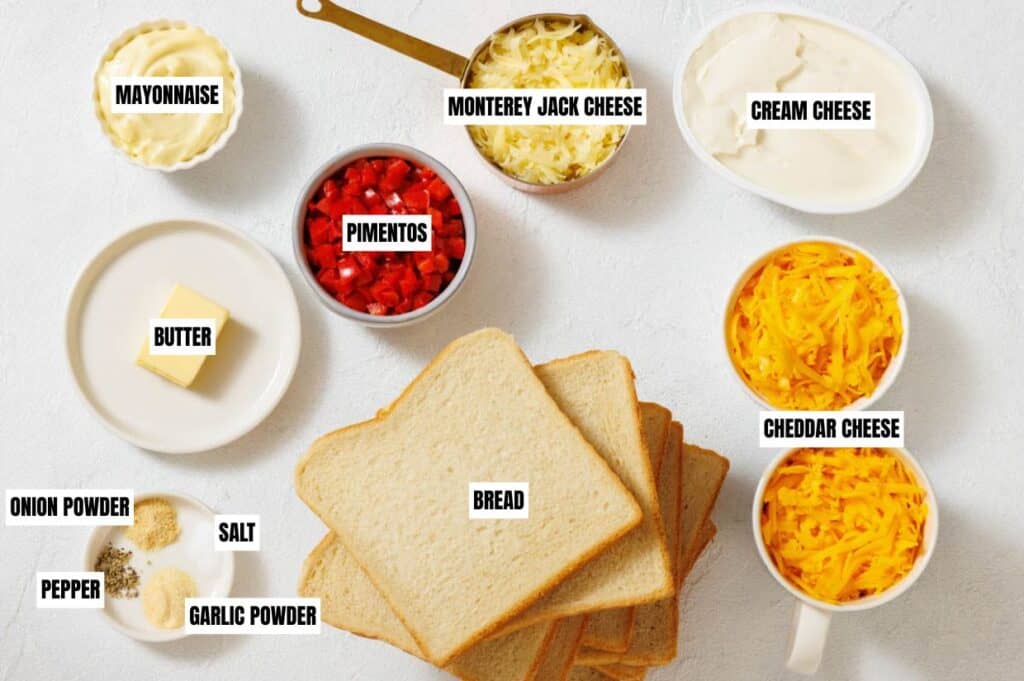 Ingredients for a pimento cheese sandwich, including bread, cheeses, pimentos, mayo, butter, and spices