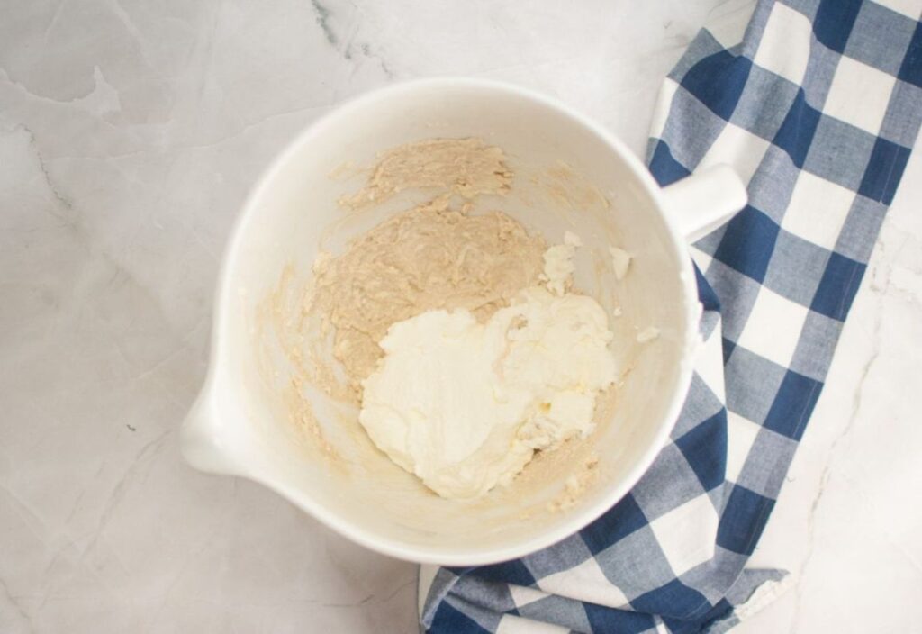 Cream cheese and whipped cream combined, ready to be folded together.