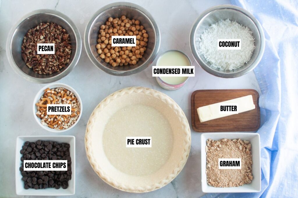 A slice of pie with a scoop of vanilla ice cream on top, featuring nuts and chocolate chunks.