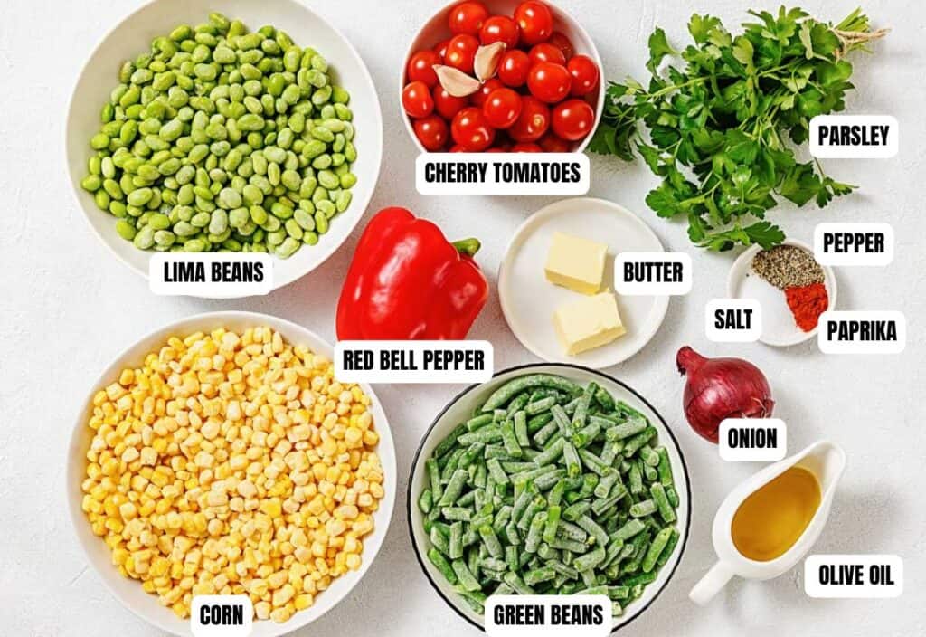 A colorful assortment of ingredients labeled on a table: lima beans, cherry tomatoes, red bell pepper, corn, green beans, onion, parsley, butter, olive oil, salt, pepper, and paprika.