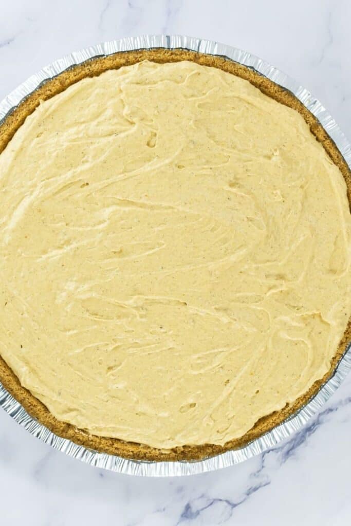 Sweet pumpkin pie in a disposable aluminum pan, ready for Southern comfort cuisine.