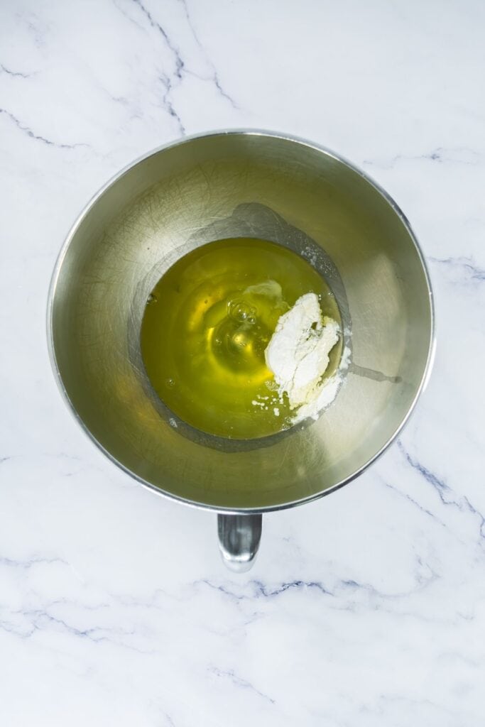 Egg whites and cream of tartar in a bowl.