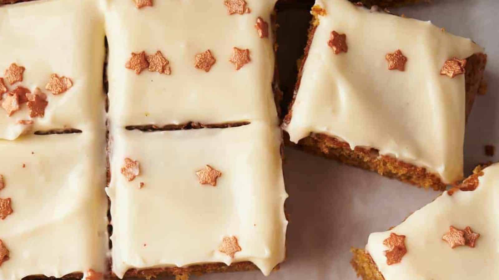 Close-up of cake slices topped with white frosting and decorated with small, star-shaped sprinkles.