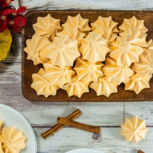 Pumpkin meringue cookies on wooden platter, autumn decor, Southern Supper Club, festive holiday dessert.