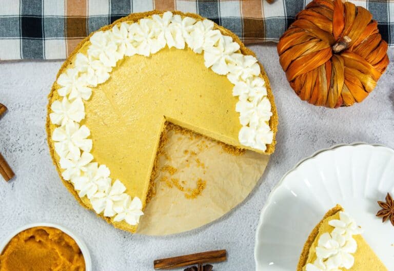 Creamy pumpkin pie with whipped topping and graham cracker crust for Southern comfort desserts.