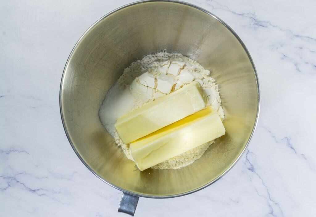 Butter, flour, sugar, and salt in stand mixer bowl.