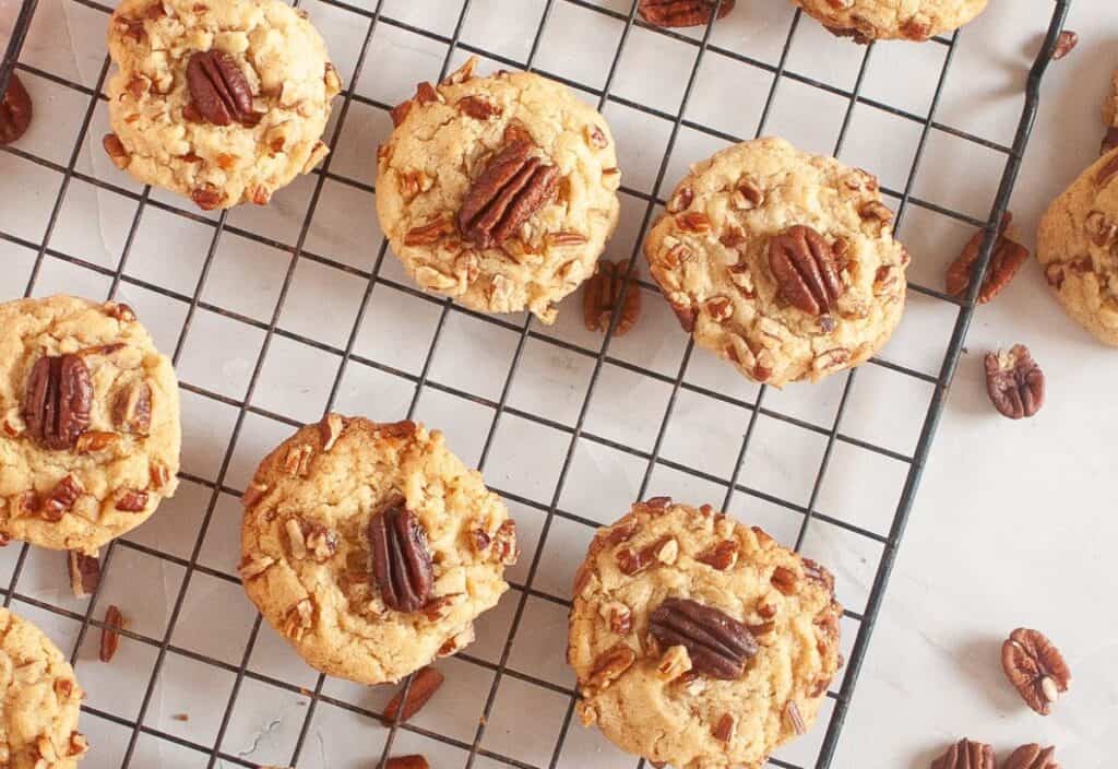 Butter pecan cookies cooling on a wire rack.