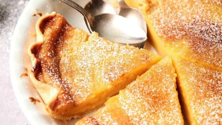 A slice of chess pie, a rich, sweet custard pie with a golden, flaky crust.