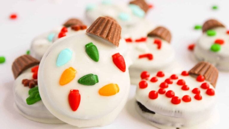 Oreo cookies turned into colorful Christmas ornaments with festive chocolate and candy decorations.