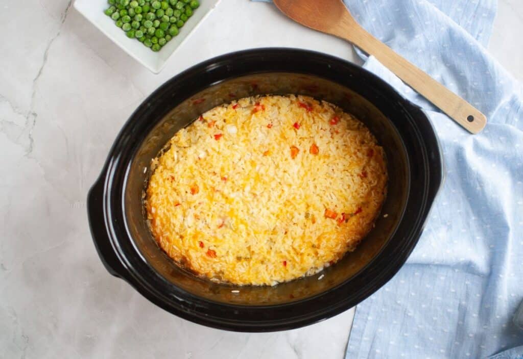 The cooked chicken and rice mixture set into a firm layer inside the slow cooker.