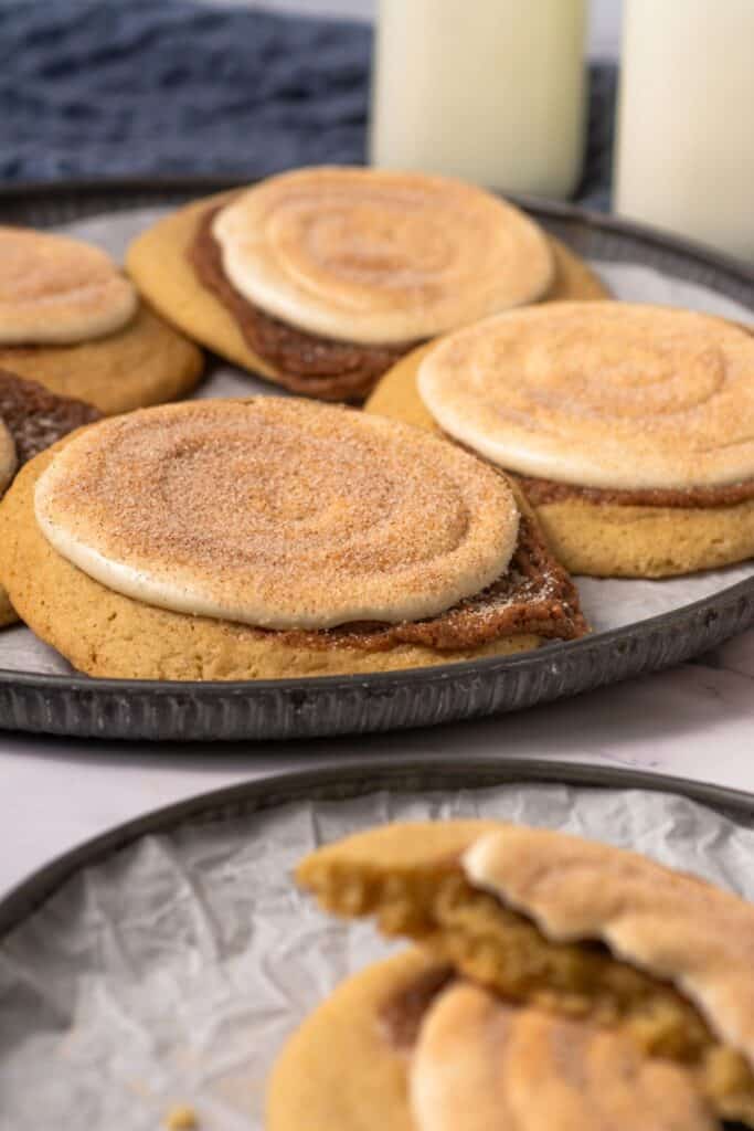 Close-up of soft cinnamon swirl cookies with cream cheese frosting and cinnamon sugar topping.