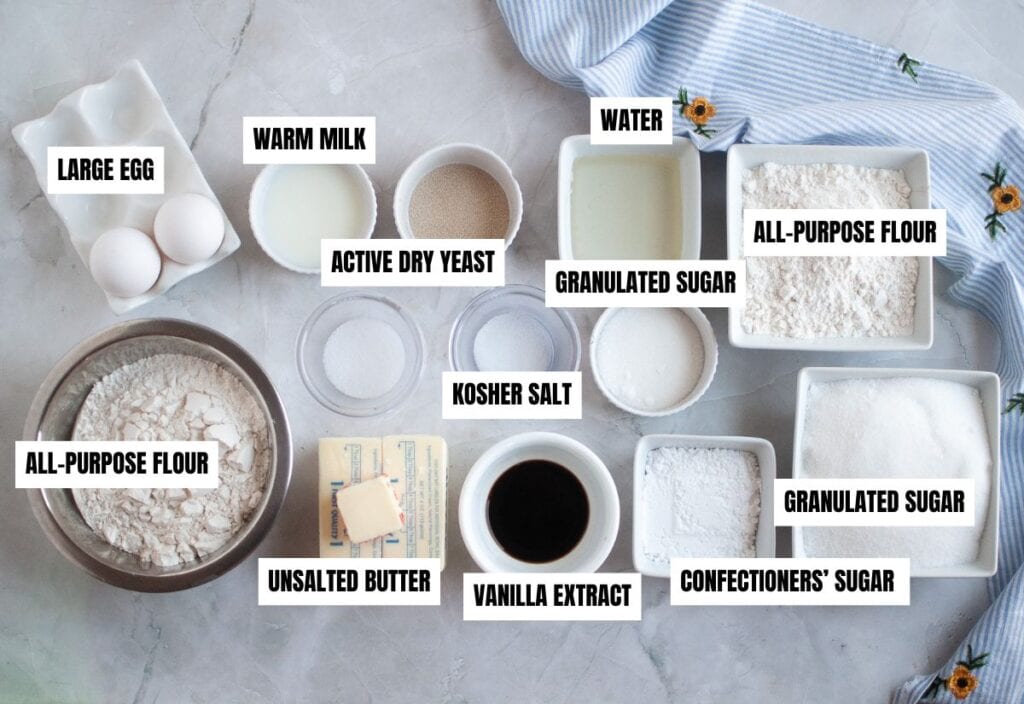Ingredients for gooey butter cake, including eggs, flour, yeast, sugar, and vanilla, arranged in small bowls with labels.