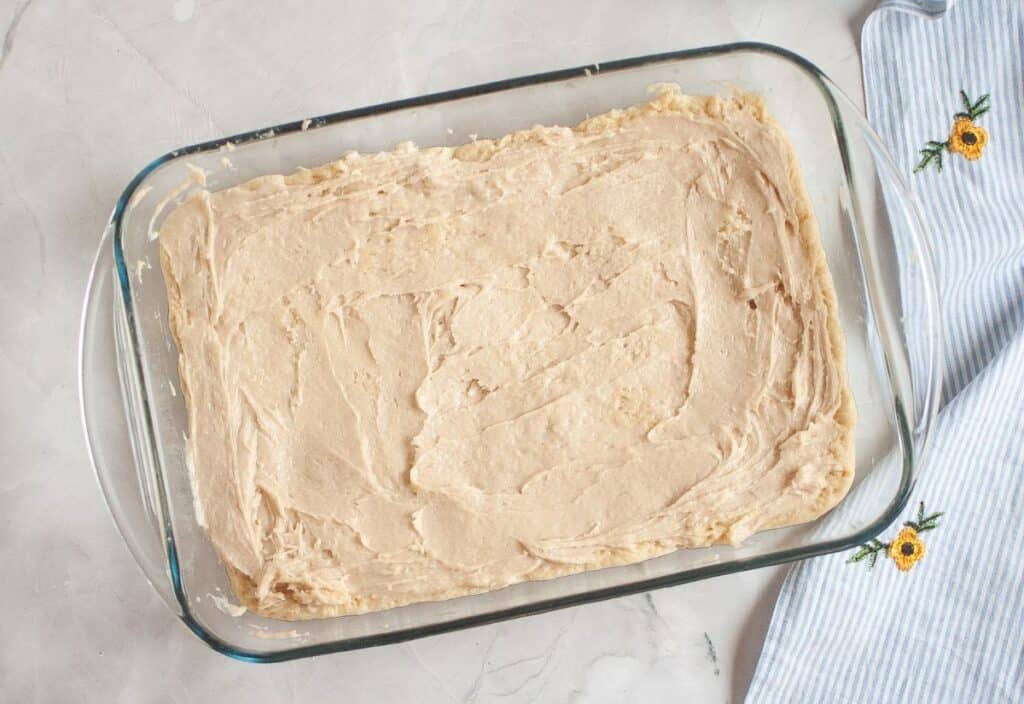 The dough spread evenly in a greased 9x13-inch pan, ready to rise.