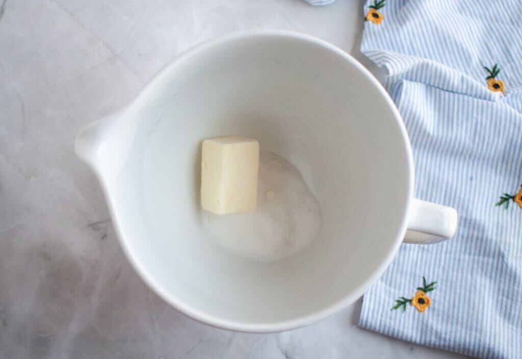 A bowl with butter and sugar in preparation for mixing in the stand mixer.