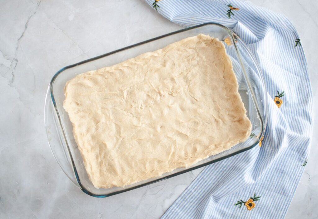 The dough spread evenly in a greased 9x13-inch baking pan.