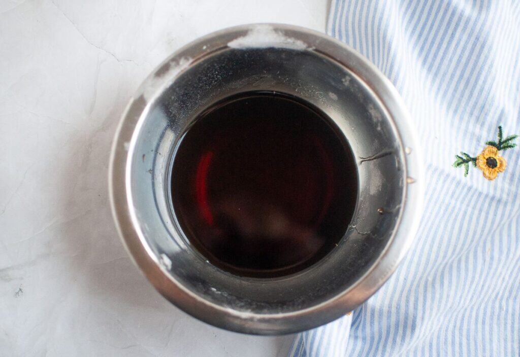 A bowl with the corn syrup, water, and vanilla mixture for the topping.