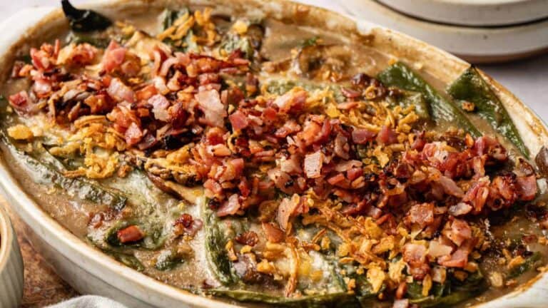 A hearty casserole of green beans, crispy bacon, and fried onions, baked until golden brown.