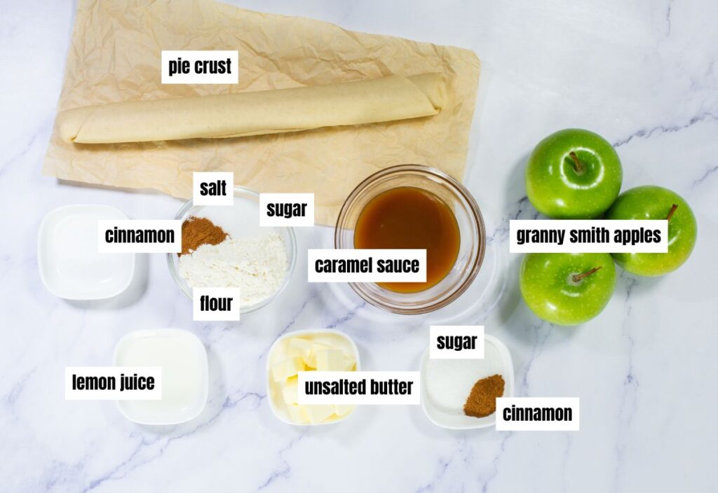 A photo showcasing the ingredients for the mini caramel apple tartlets, including Granny Smith apples, sugar, cinnamon, and pie crust.