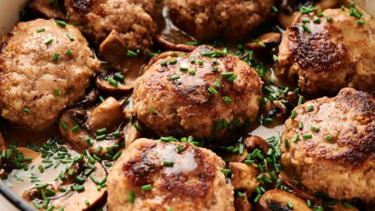 Salisbury steak with rich brown gravy and caramelized onions, served on a plate.
