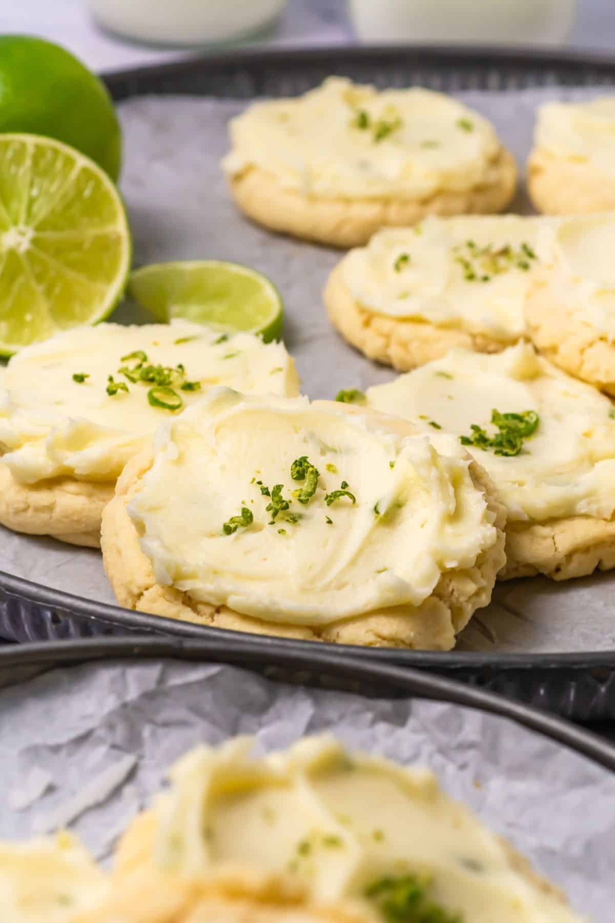 Close-up of lime-flavored cookies with cream frosting and lime zest.