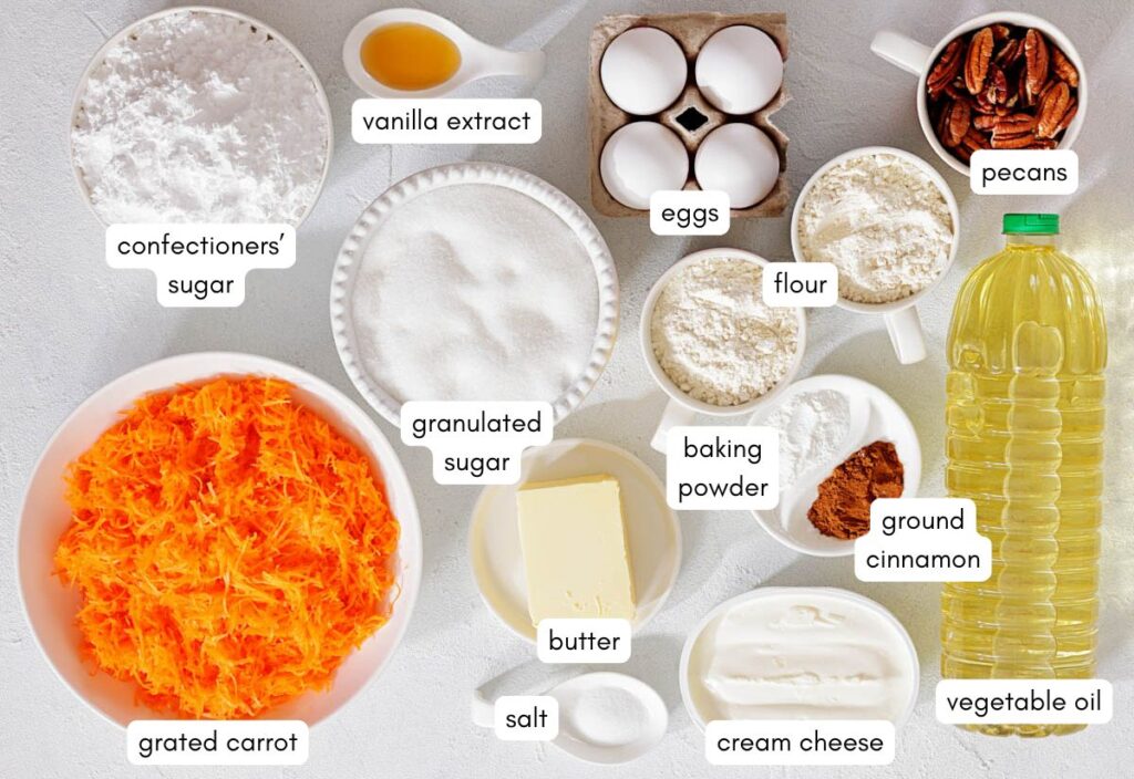 Labeled containers of carrot cake ingredients including flour, sugar, eggs, pecans, carrots, and spices.