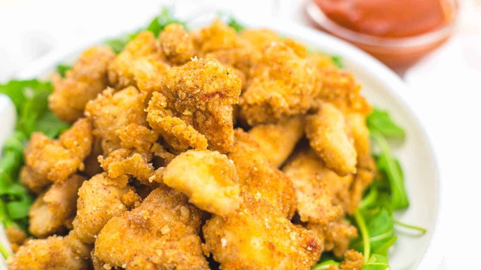 Popcorn chicken on a green leaves.