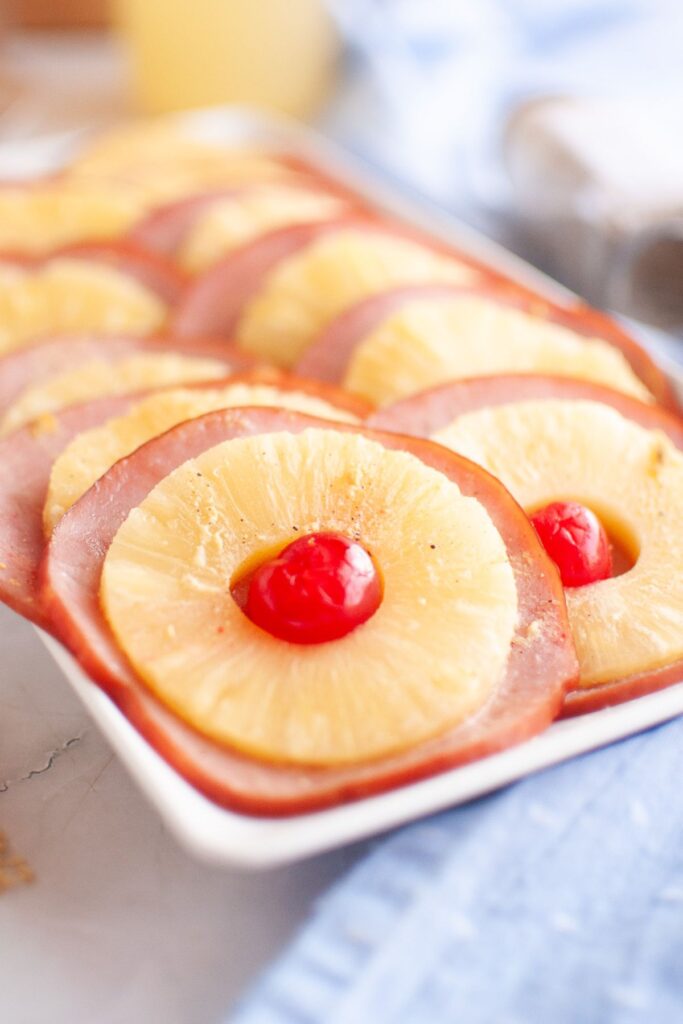 A plate full of glazed ham slices.