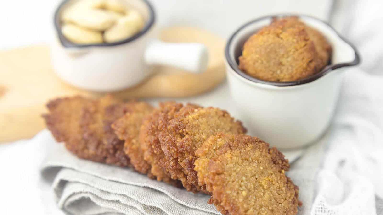 Almond Flour Keto Butter Cookies with cup filled with cookies.